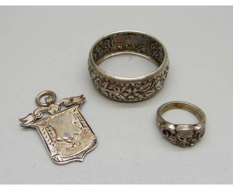 A silver ring, Moller, Trondhjem, P, a silver napkin ring and a late Victorian silver fob, Birmingham 1899 by Fattorini and w