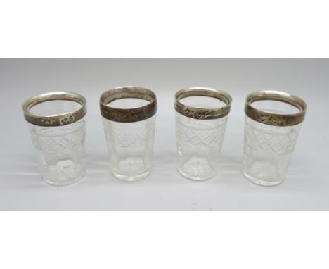 A set of four silver mounted cut glass vodka shots, W. Comyns, London 1899, one base chipped 
