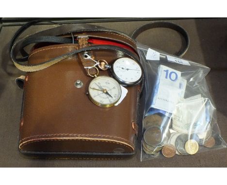 A pair of Yashica 8x40 binoculars, a stop watch, a small compass and a small quantity of coins.