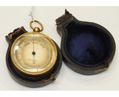 A late-19th century brass-cased pocket barometer, the silvered dial marked 'A & N.C.S.L.', 5cm diameter excluding ring, in le