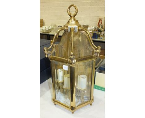 A modern brass three-light wall fitting with three glass panels, 50cm high, 28cm wide.