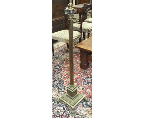 A brass lamp standard having a Corinthian column, on square stepped base and claw feet, 165cm high.