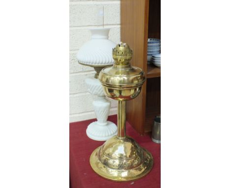 A late-19th/early-20th century white opaque glass oil lamp and shade of ribbed decoration, 57cm high overall, a brass oil lam