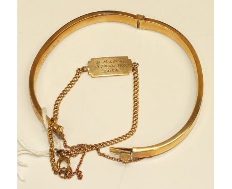 A 9ct gold hinged bangle with engraved decoration and a 9ct gold identity bracelet, 11.7g, (2).