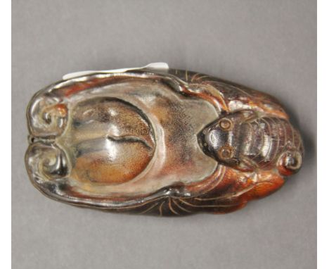 An interesting Chinese carved cattle hoof lucky amulet, depicting a bat and peach, H. 10cm.