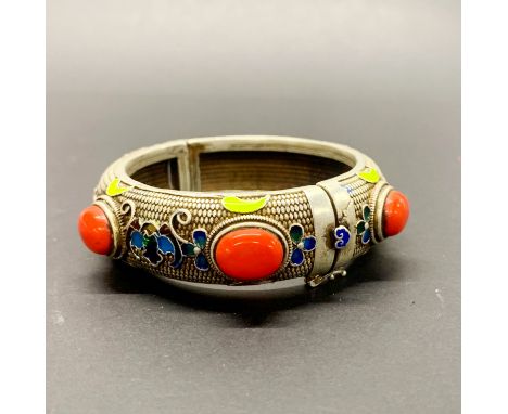 A Tibetan enamelled silver on copper heavy bangle, W. 2.2cm, internal Dia. 6cm.