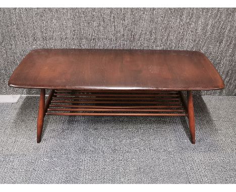 A matching Ercol oak coffee table with ladder style shelf, 103 x 46 x 36cm.