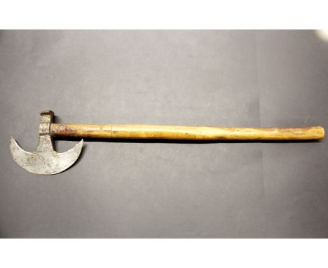 A brass decorated steel and wood tribal axe, L. 59cm. Prov. Estate of the late Dr. James (Jim) Bynon.