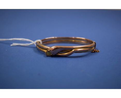 A Victorian 9ct gold hinged snake bangle having collet set cabochon ruby eyes.11.3g total.   Condition Report:  Dents in seve