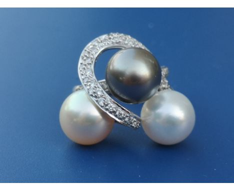 A South Sea pearl &amp; diamond set 18ct white gold ring, having three pearls of differing colours, approximately 9.9mm diame