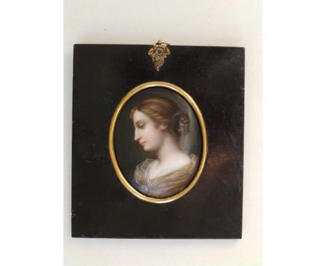 A 19thC oval enamelled porcelain miniature portrait of a young woman in profile, 3.1".