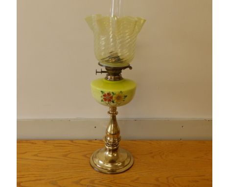 A Victorian brass column oil lamp with painted green glass font &amp; vaseline glass shade, 22" high excluding chimney.