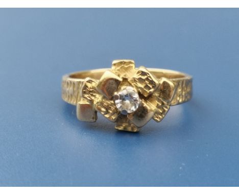 An Alan Martin Gard 18ct gold band ring set with a small central diamond within a paved design - London marks.  Finger size K