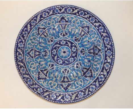 A 19thC Eastern blue &amp; white circular wall plaque, the raised decoration  of bands of arabesque scroll and flowers painte