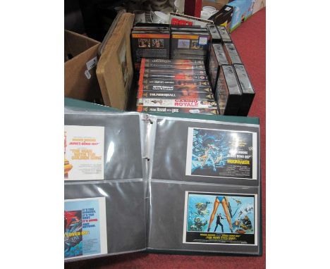 James Bond 007 - postcards in album, VHS videos, two German cigarette card albums.