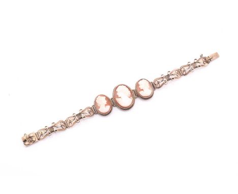 A 9ct yellow gold cameo bracelet consisting of seven articulated sections with three graduated shell cameos sections, the cen