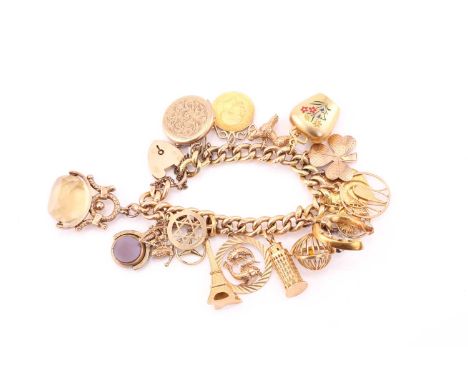 A yellow gold charm bracelet, consisting of various charms individually hallmarked as 9ct or 18ct, with a 1929 full sovereign