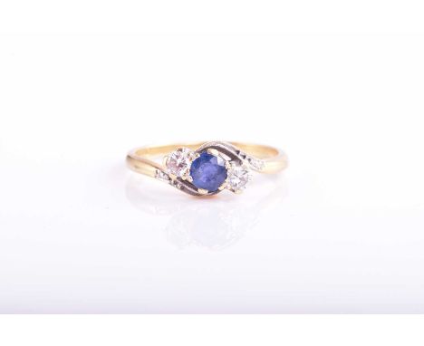 A sapphire and diamond three stone cross over ring; the circular cut sapphire and round brilliant cut diamonds in claw set, b