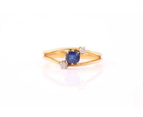 A sapphire and diamond three stone ring, consisting of a cushion-cut sapphire approximately measuring 4.0 x 5.0 mm, flanked w