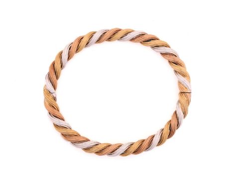 A 9ct tri-coloured gold twisted bangle, with tongue and groove clasp, a figure of 8 safety catch, Sheffield hallmarked with f