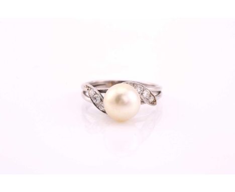 A cultured pearl and diamond ring, mid 20th century, the 8.7mm light cream pearl, with three graduated round brilliant cut di