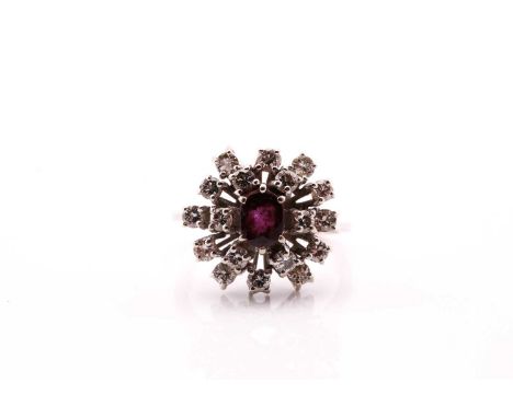 A ruby and diamond set cluster ring, consisting of a central oval ruby surrounded by round brilliant-cut diamonds weighing an