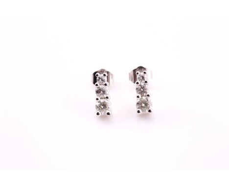 A pair of diamond ear studs, each consisting of three graduated round brilliant diamonds, estimated weight of 0.19ct, claw se