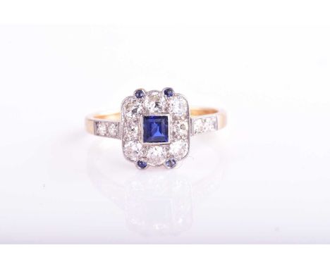 An Art Deco sapphire and diamond ring; the central square plaque with a step cut sapphire within a border of round brilliant 