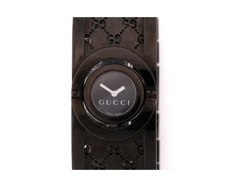 A lady's Gucci bangle Twirl watch, with a rotating central quartz movement watch on a rigid stylised bangle bracelet in Ion-p