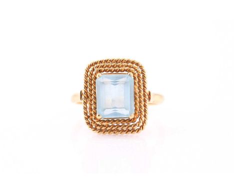 An aquamarine dress ring, consisting of an emerald cut blue aquamarine, sized approximately 8.7 x 7.7 mm, set in four claws o