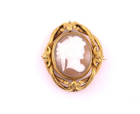 A Victorian shell cameo brooch, the central swivel oval with carved classical female profile portrait to one side, and glazed