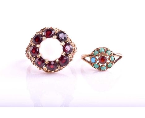 A large opal and garnet circular cluster ring, claw set within a 9 carat gold bark finish mount and shank. Ring size R1/2; to