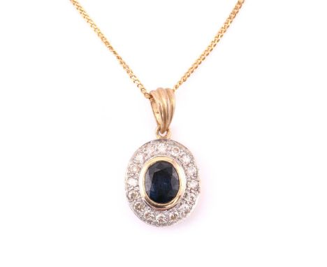 A modern diamond and sapphire pendant, consisting of an oval natural dark blue sapphire, measuring 5.9 x 4.5 mm, rub over set