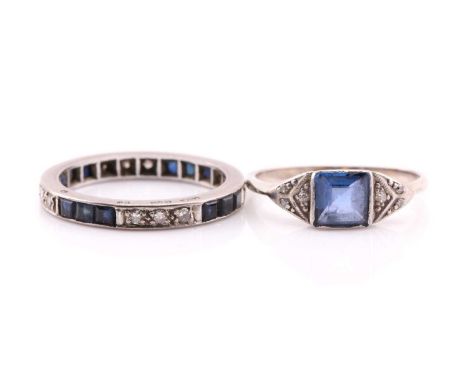 An Art Deco sapphire and diamond ring; the square-cut sapphire in rub-over mount to three stone diamond set shoulders in mill