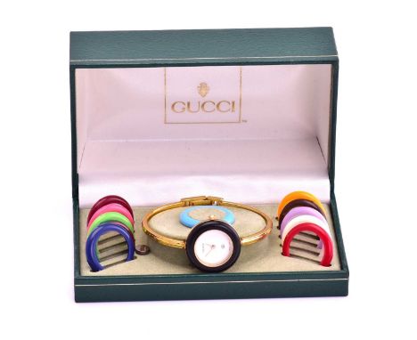 Cancer Research UK Charity lot - A 1980's Gucci wristwatch and bezel set, with a quartz movement and gilt case measuring 26mm