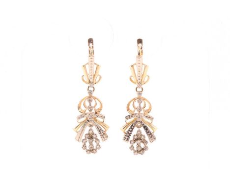 A pair of 14ct gold diamond drop earrings, each consisting of round diamonds claw set on a yellow metal mount hallmarked as 5