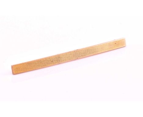 A rectangular 14ct yellow metal bar brooch, with engine turned decoration, overall 9cm long, stamped 14k to the safety catch.