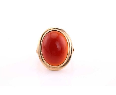 A carnelian cabochon ring, mid 20th century, the 19 x 14.5mm oval cabochon collet set to a yellow gold mount and tapering sha