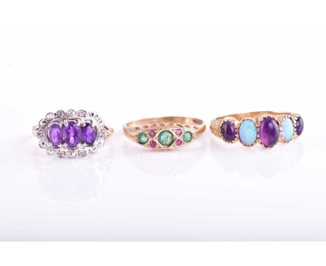 A five stone half hoop opal and amethyst ring in 9 carat gold mount; together with an emerald and ruby seven stone half hoop 