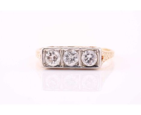 A three-stone diamond panel ring, consisting of three round diamonds estimated weight of 0.57ct, set in a white metal panel w
