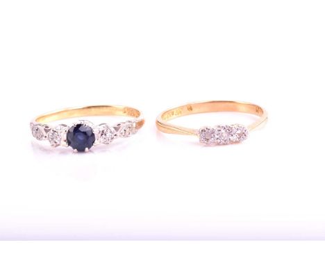 A lot consisting of two rings, the first is an 18ct bi-coloured gold three-stone ring, comprises of a round natural sapphire 