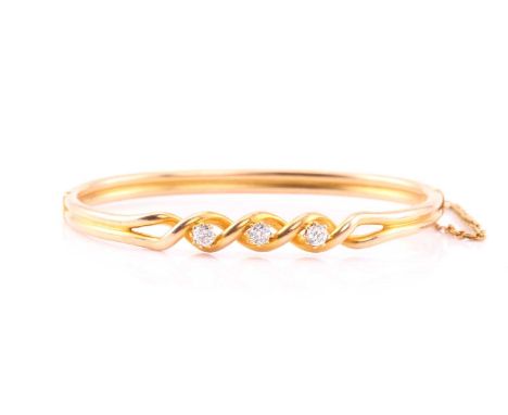 A diamond set hinged bangle, consisting of three round brilliant diamonds of an estimated weight 0.48cts, claw set on a twist
