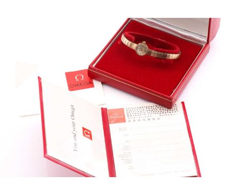 A lady's 9ct yellow gold Omega wristwatch and bracelet with a hand-wound caliber 650 movement in a 14mm round case with gold 