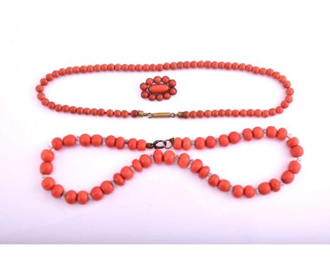 A lot consisting of two coral necklaces and one coral brooch, the first necklace consists of 8.8mm beads with glass spacers w