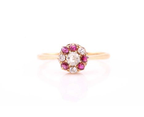 A diamond and ruby cluster ring, consisting of an old European cut diamond estimating 0.16ct in the centre, encompassed by th