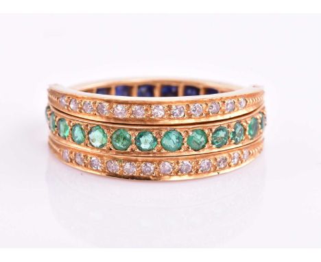 A diamond, sapphire and emerald swivel ring, set with a central pave set band of round emeralds and sapphires with two articu