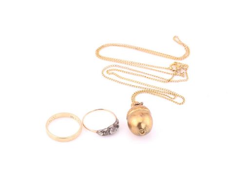 A 9 carat gold wedding band; a five stone half hoop ring set in silver and gold; and an acorn pendant to a gilt metal chain. 