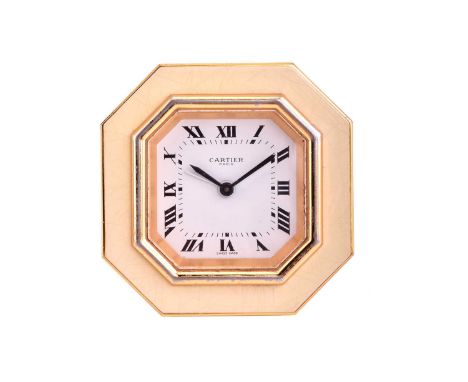 Cartier. A gilt metal and cream enamel desk clock; octagonal with a hinged back strut. Signed and numbered.No box or papersCl