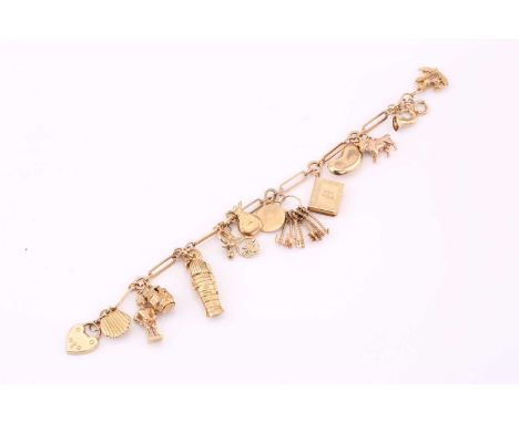 A 9ct yellow gold charm bracelet, consisting of various charms attached on a Figaro chain, with a spring clasp, approximately