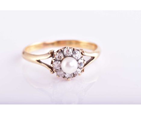 A pearl and diamond cluster ring; the central single stone cultured pearl within a border of mixed old cut and round brillian